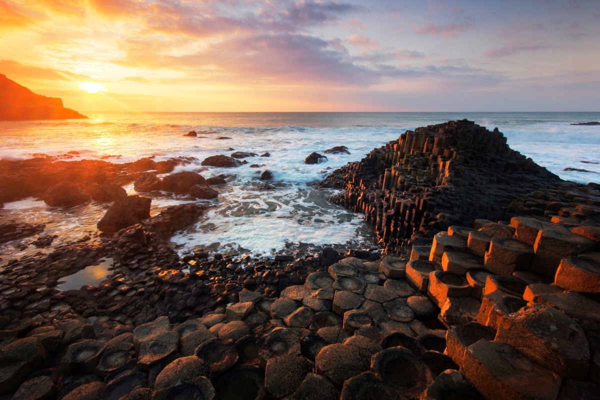The hexagonal stones of Giant's Causeway rising out of the sea